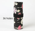 Square canvas rolling pencil case with ballet girl print, showing multiple pencil slots inside.