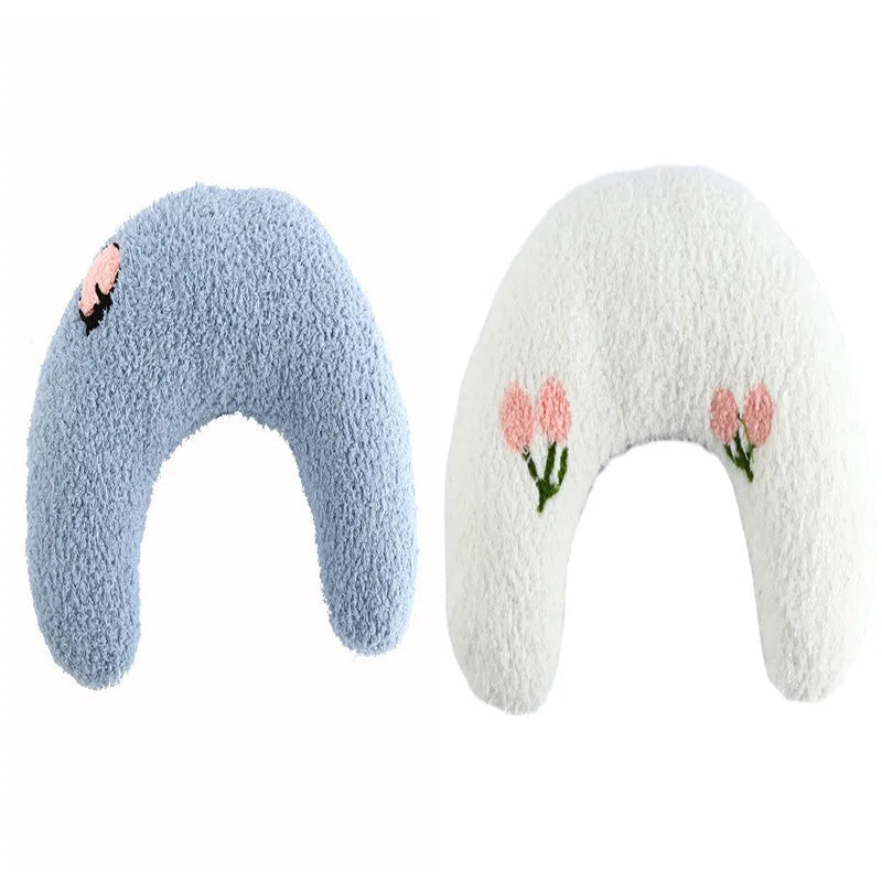 Small blue U-shaped plush pillow for cats or small dogs on a white background.