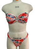 Blue floral print tube top bikini set with lace trim on a mannequin.