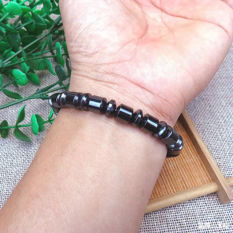 Black stretch bracelet with a pentagram design made from magnetite and hematite stones.