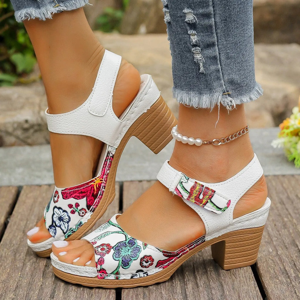 White women's high heel sandals with a Velcro strap buckle and rubber sole.