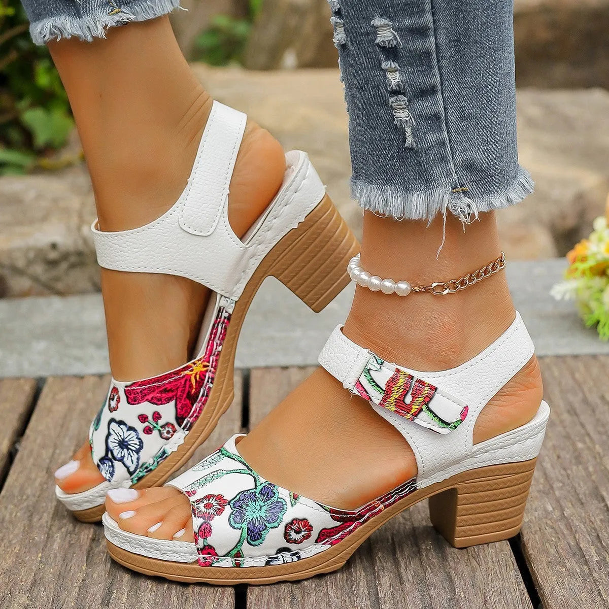 White women's high heel sandals with a Velcro strap buckle and rubber sole.