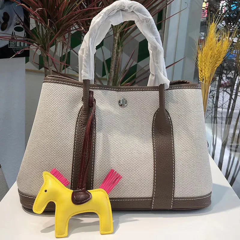 Genuine leather women's crossbody tote bag with canvas lining in bucket shape