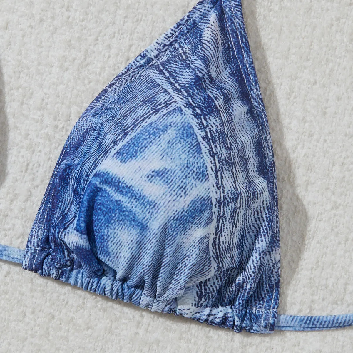 Women's denim blue printed bikini swimsuit with strap design on a hanger