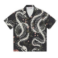Short sleeve loose fit shirt with snake bone and floral pattern print and a Cuban collar.