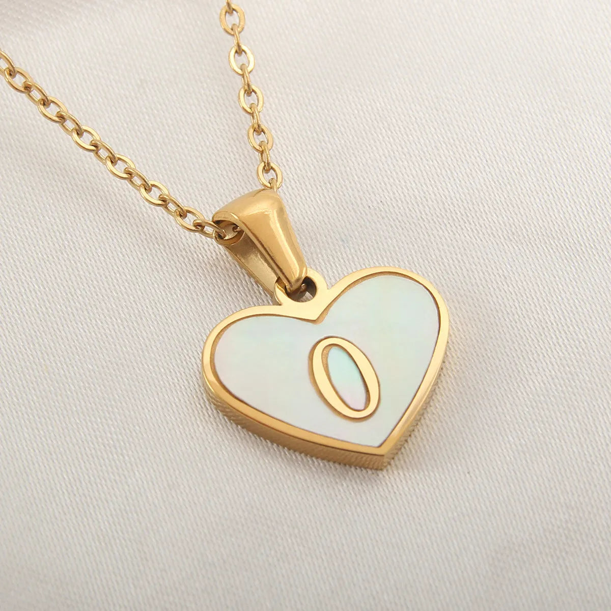 Gold plated heart-shaped personalised necklace with white shell charm on an adjustable chain.