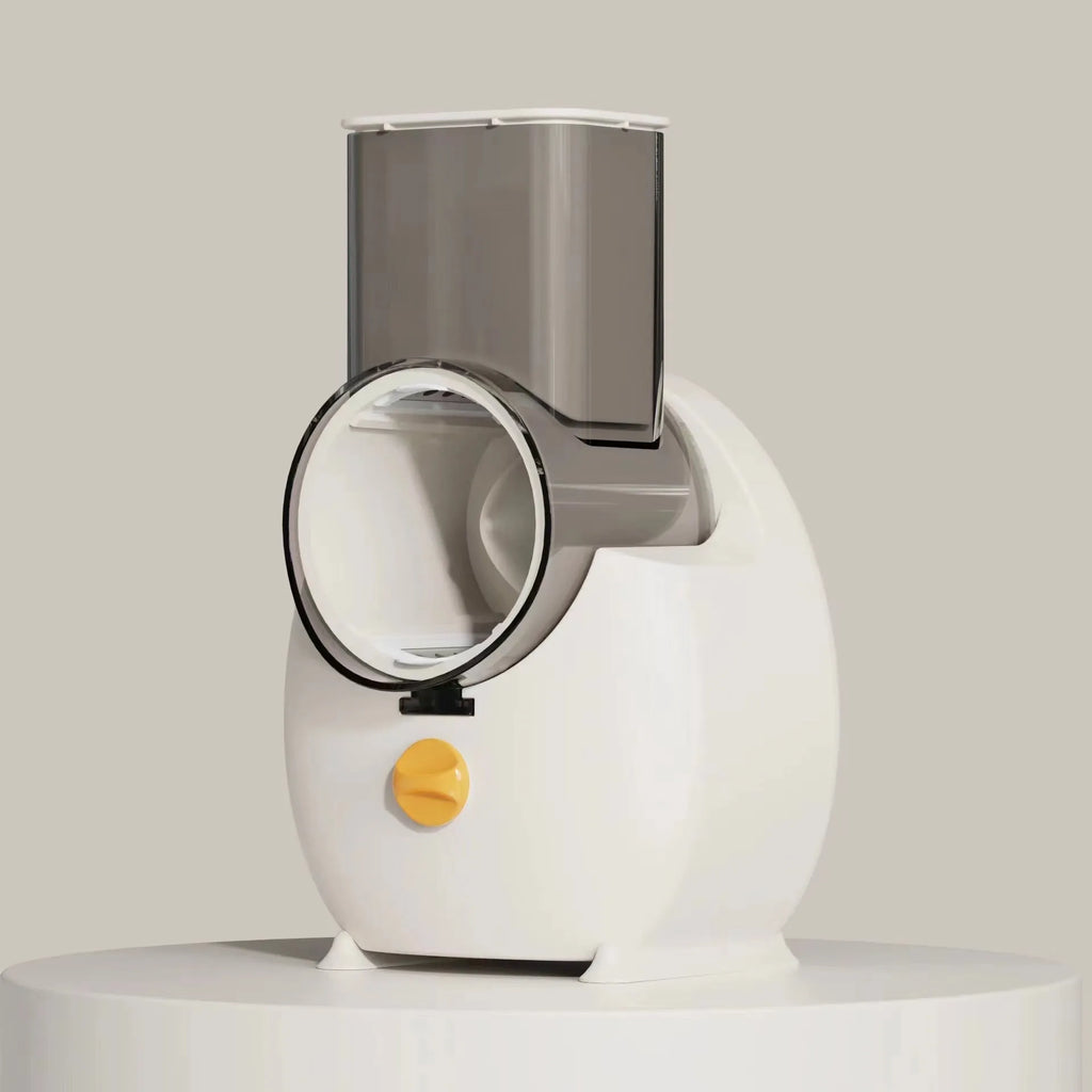 White electric vegetable slicer with rotary grater, feeding port, and strong suction base on a kitchen counter.
