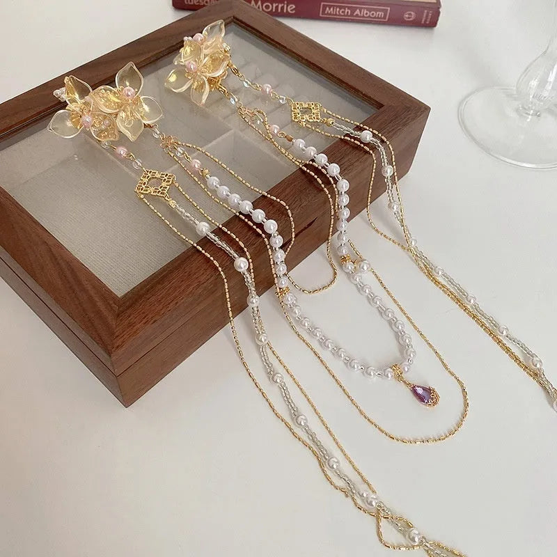 Gold women's hairpin with pearl, diamond and tassel decorative elements
