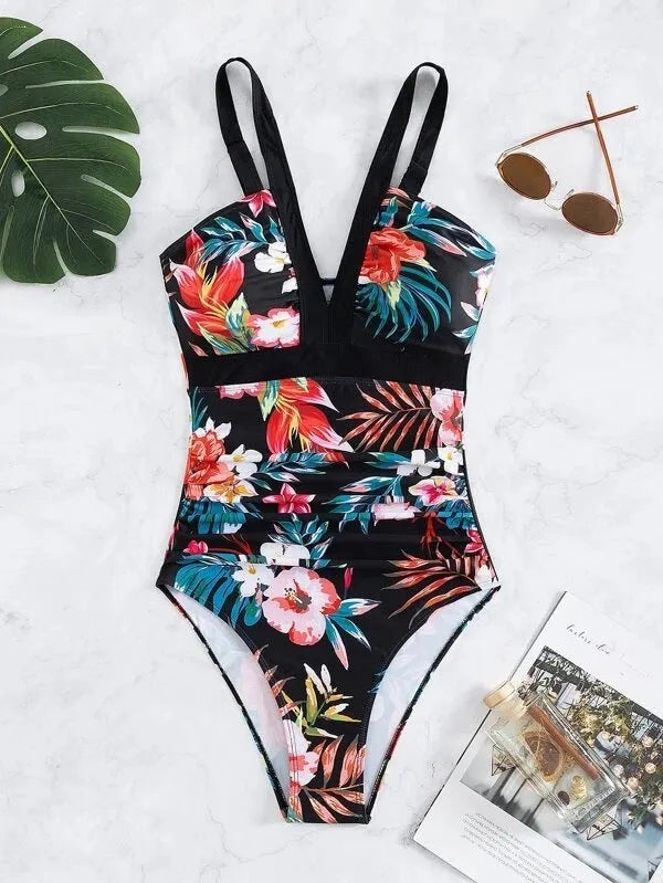 Women's floral patterned, backless one-piece swimsuit on a hanger