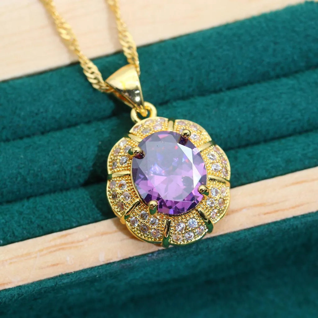 Gold coloured necklace, earrings, ring, and bracelet set with blue synthetic cubic zirconia stones.