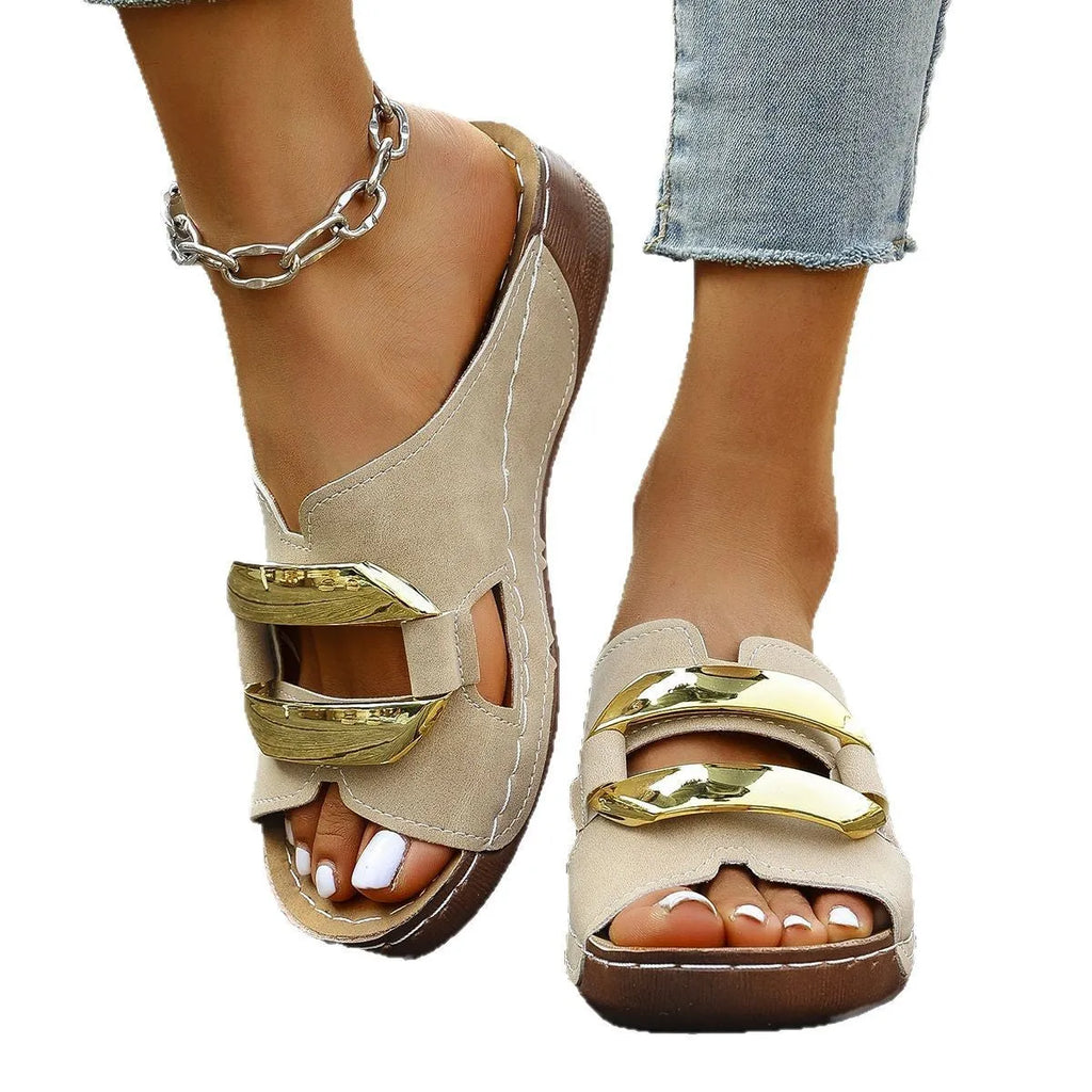 Roman-style platform flip-flops in a solid colour with a metal detail and rubber sole.
