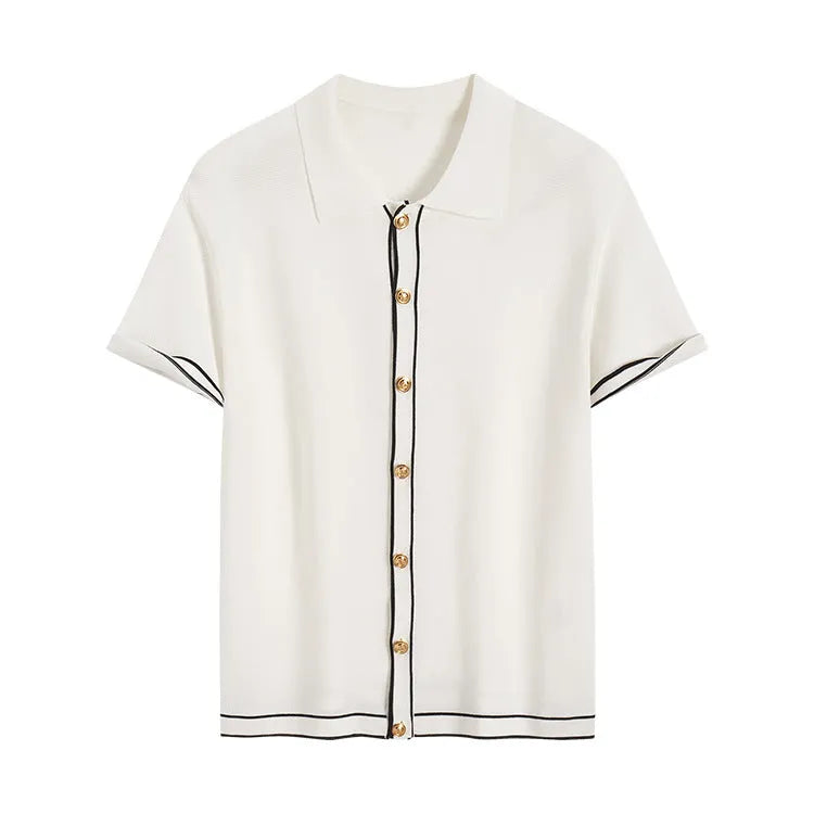 White short-sleeved cardigan with dark contrast lapels laid flat.
