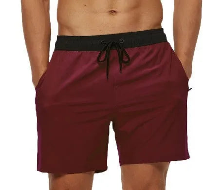 Men's blue drawstring shorts with a zippered pocket and stitching waist detail