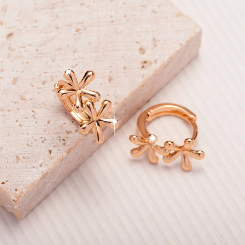Circular rose gold electroplated earrings with a waterdrop floral design