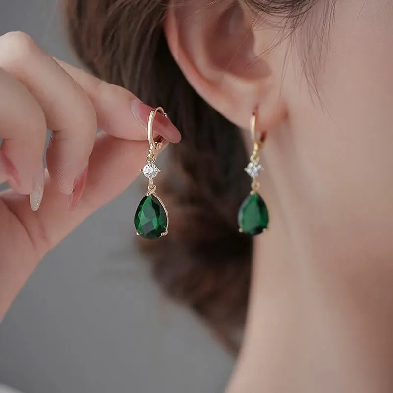 Green geometric teardrop earrings with alloy construction showing structured patterning