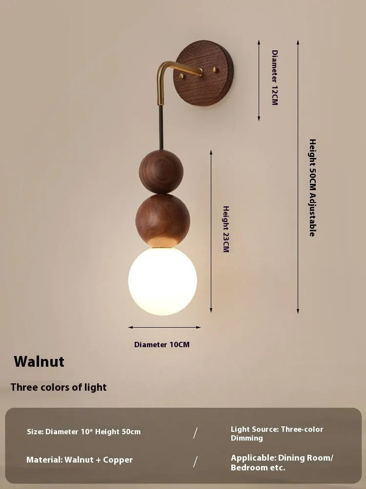 Walnut and copper suspension wall lamp with tri-colour light on a wall