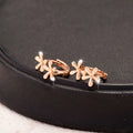 Circular rose gold electroplated earrings with a waterdrop floral design
