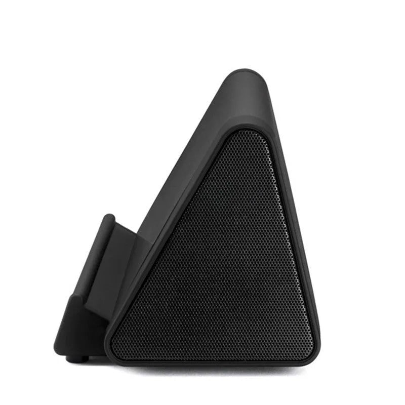 Compact black or white wireless Bluetooth speaker with a built-in microphone for calls.