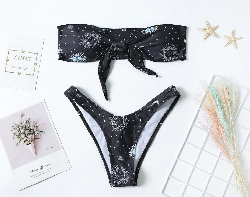 Black one-piece swimsuit with printed pattern and backless design for women