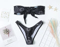 Black one-piece swimsuit with printed pattern and backless design for women