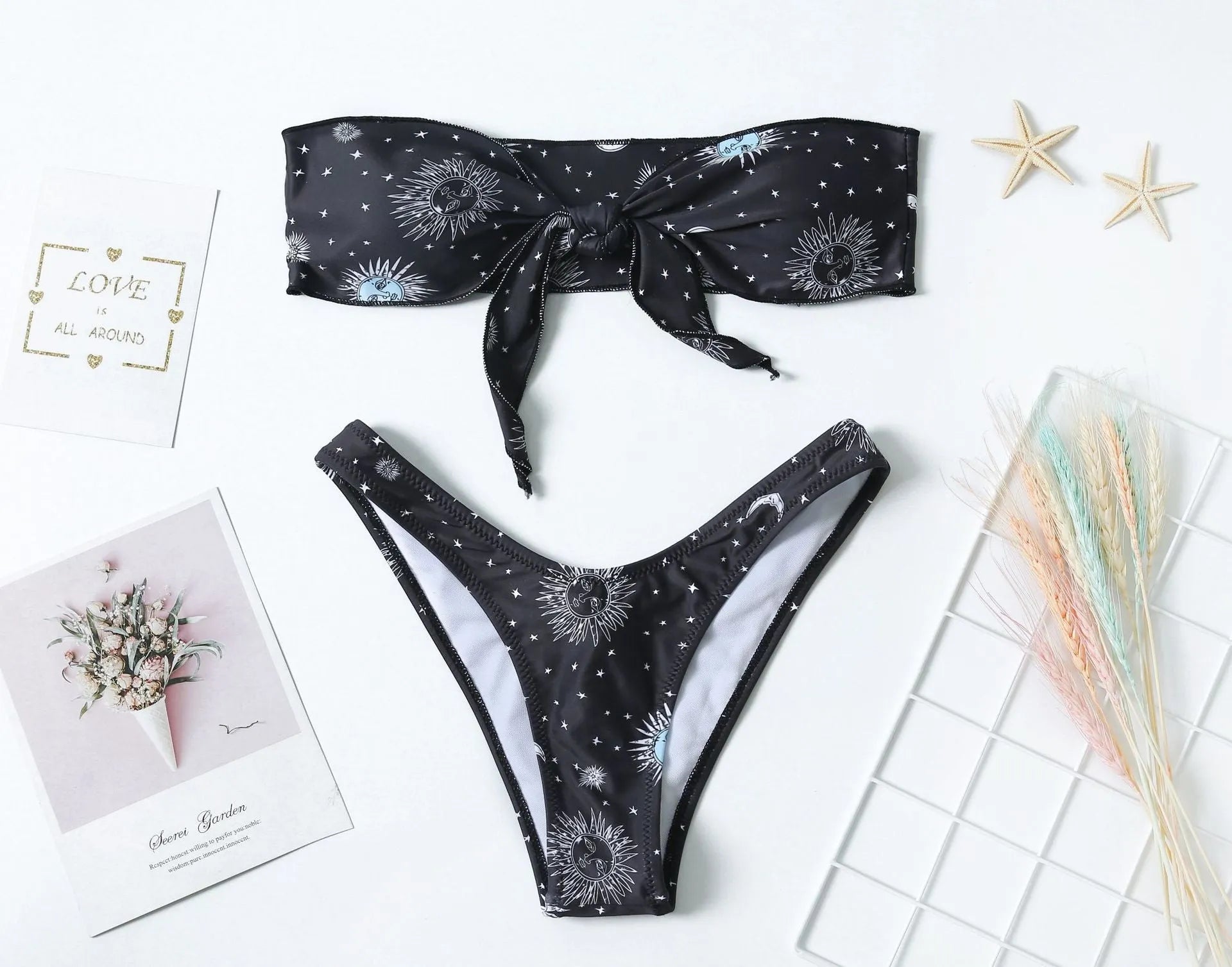 Black one-piece swimsuit with printed pattern and backless design for women