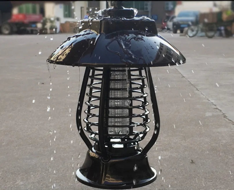 White outdoor solar mosquito lamp with purple switch and solar panel on top for garden insect control.