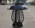 White outdoor solar mosquito lamp with purple switch and solar panel on top for garden insect control.