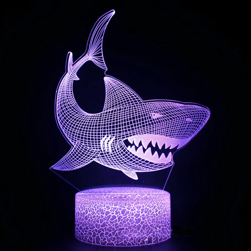 3D acrylic LED table lamp with remote control on a desk, showing colourful illumination.