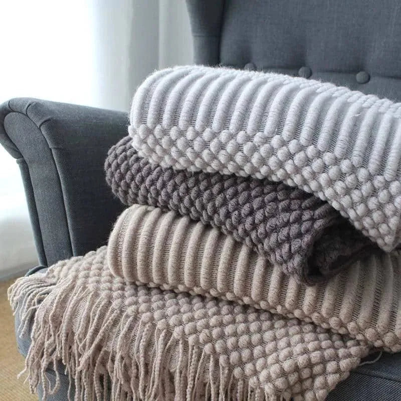 Small light grey polyester nap blanket folded, showing its 127cm by 170cm size.