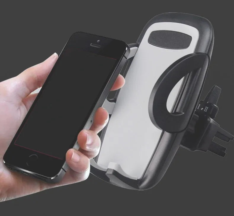 Black plastic universal mobile phone holder attached to a car air vent.