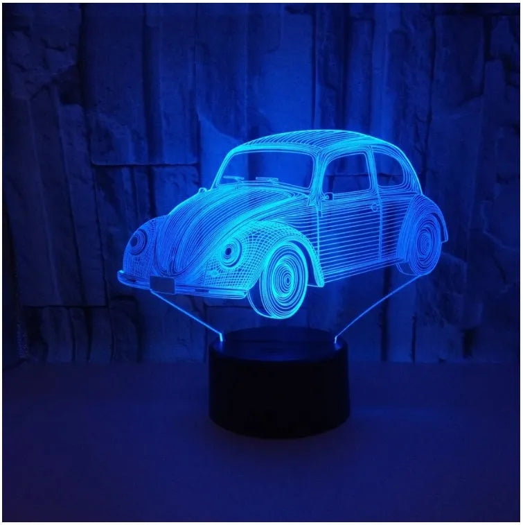 Small 3D LED table lamp with colourful acrylic shade and remote control on wooden desk