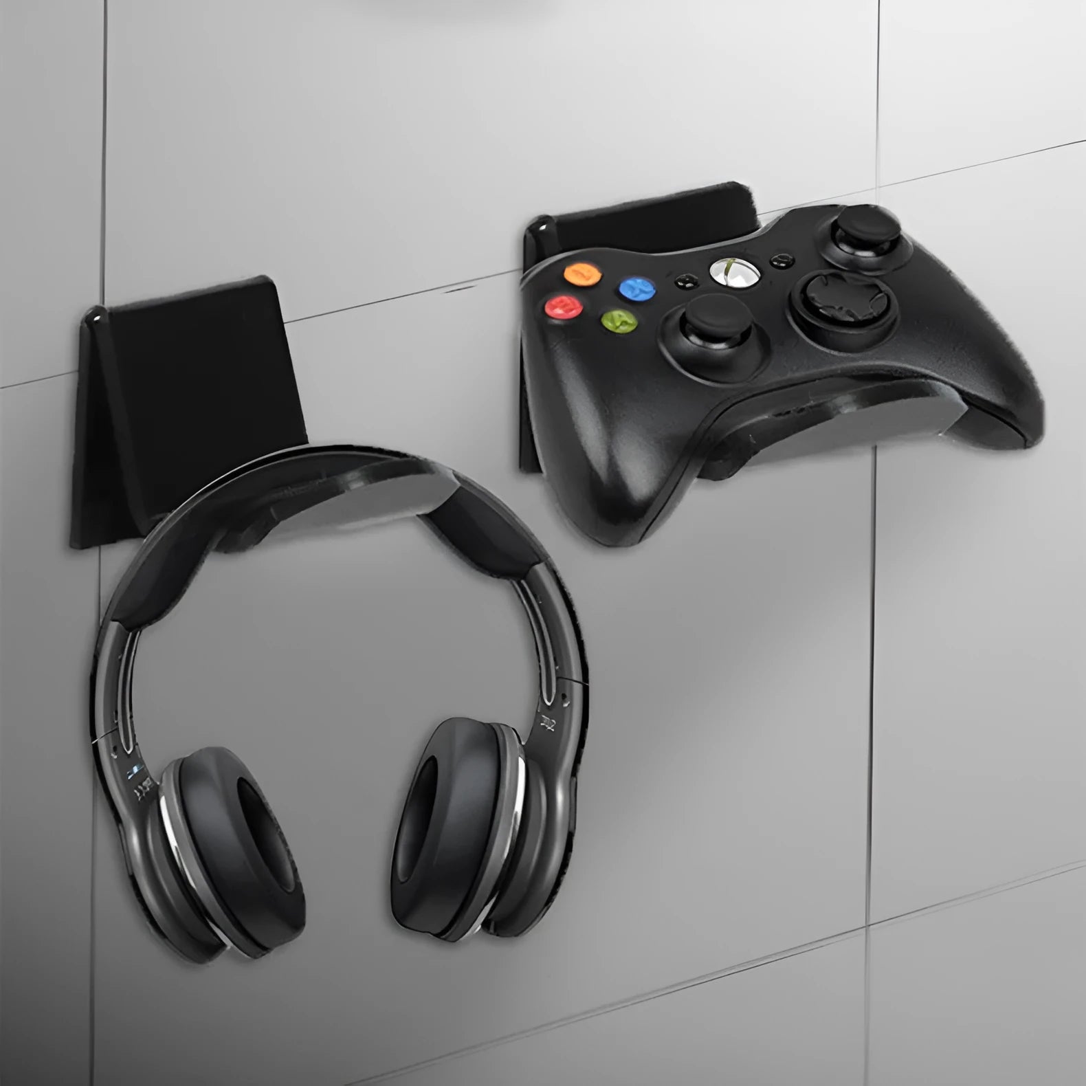 A universal plastic wall mount bracket for game controllers, shown in black, white, and transparent colour options.