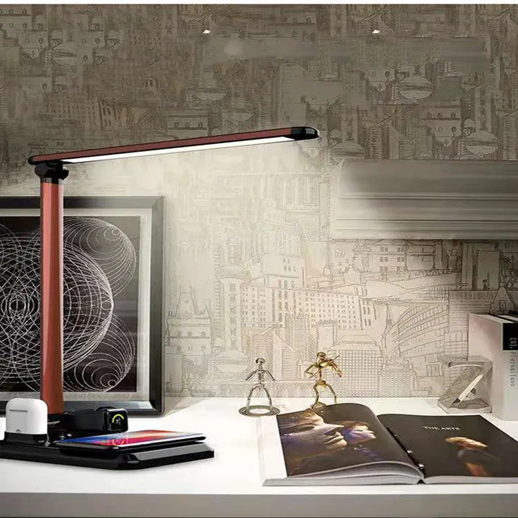 Black and white 4-in-1 LED desk lamp with integrated wireless charging pad.