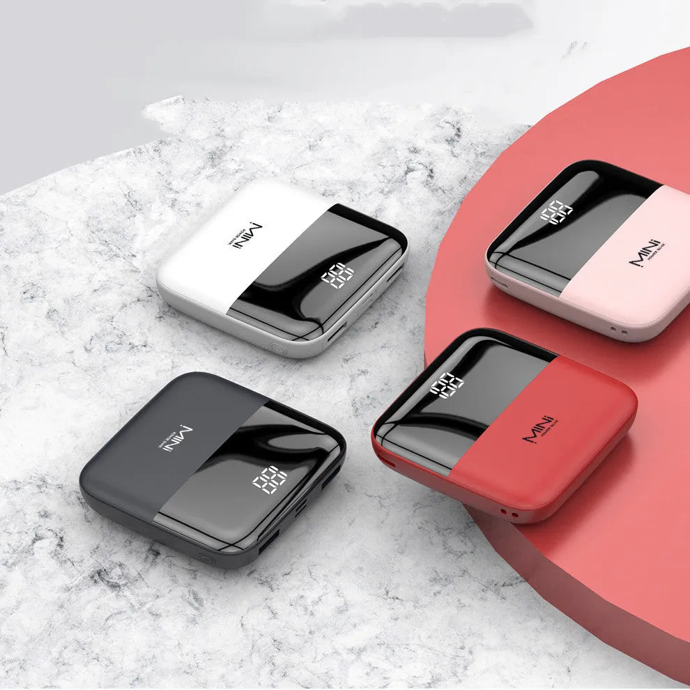 White portable power bank with digital display showing battery percentage and two USB ports.
