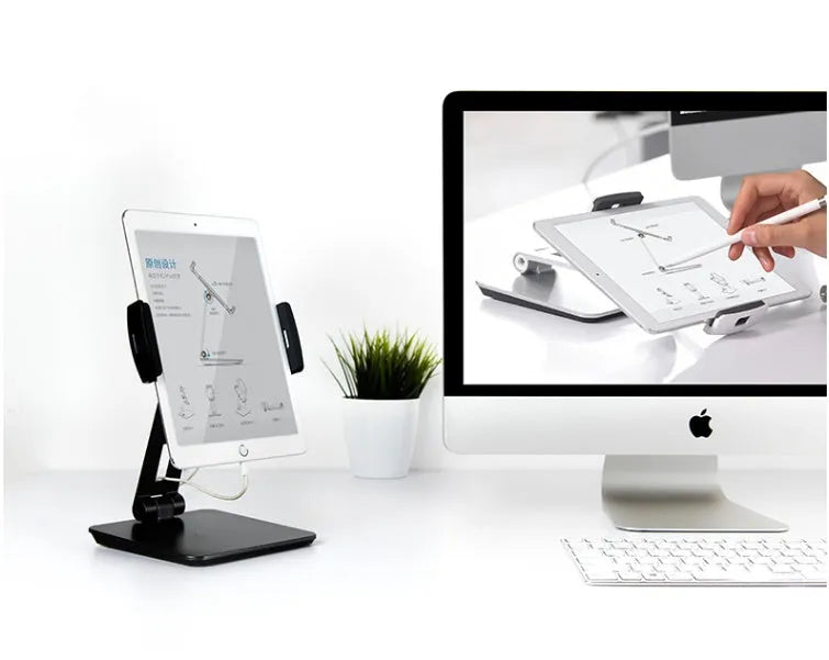 Folding aluminium phone and tablet stand on a desk, shown in silver colour with 360-degree rotation.