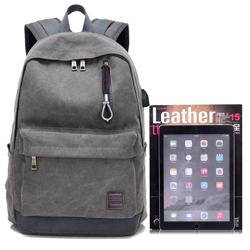 Canvas backpack with USB charging port showing multiple compartments including laptop section