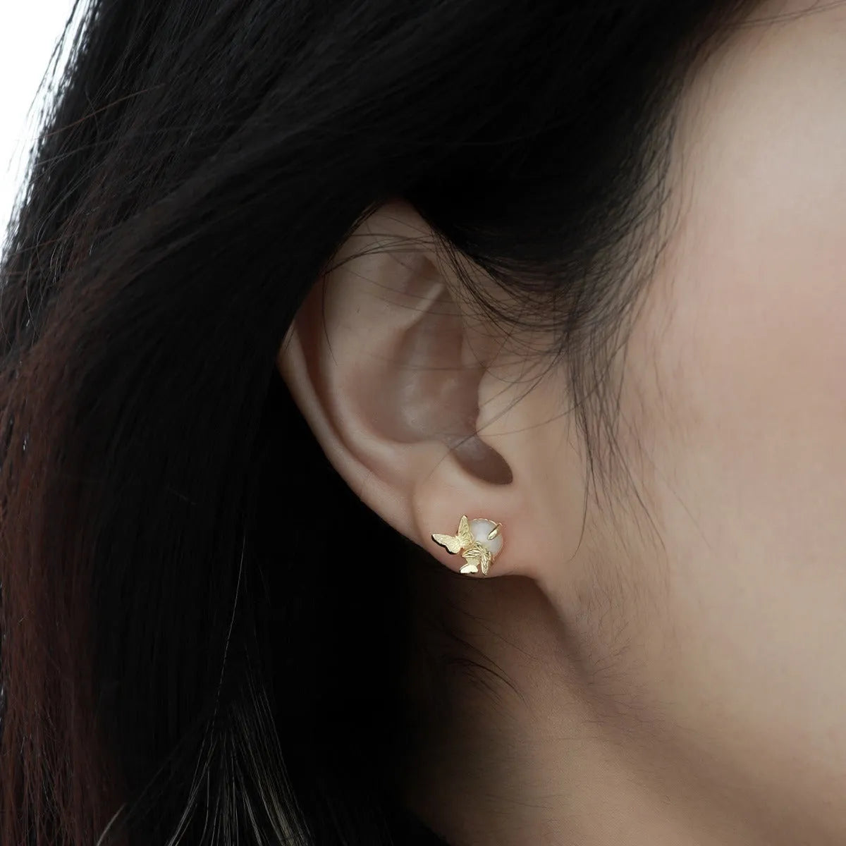 A pair of silver 925 butterfly stud earrings with an animal zodiac design in a gold colour finish.