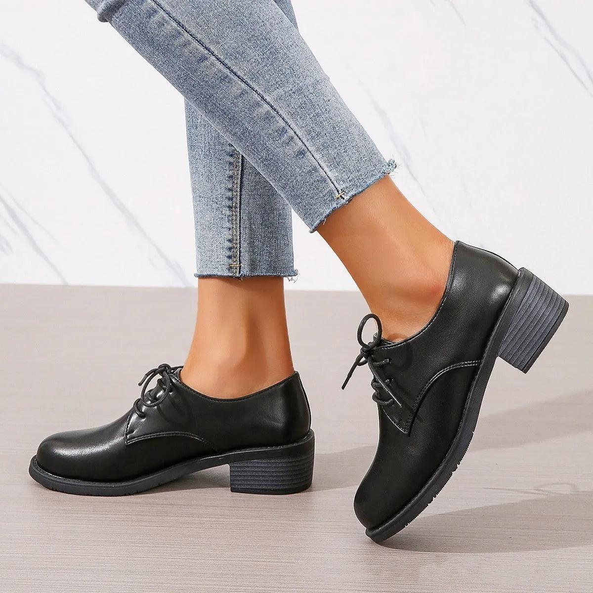 Black women's low-top work shoes with a chunky mid-heel and rounded toe.