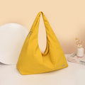 Heart-shaped soft nylon crossbody bag for women in black, blue, khaki, or yellow.