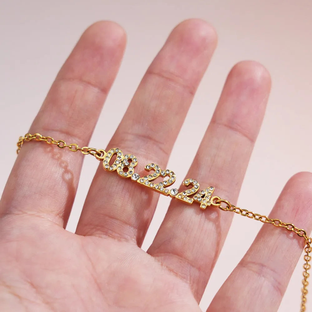 Stainless steel digital bracelet with diamond studded numbers, matching necklace option