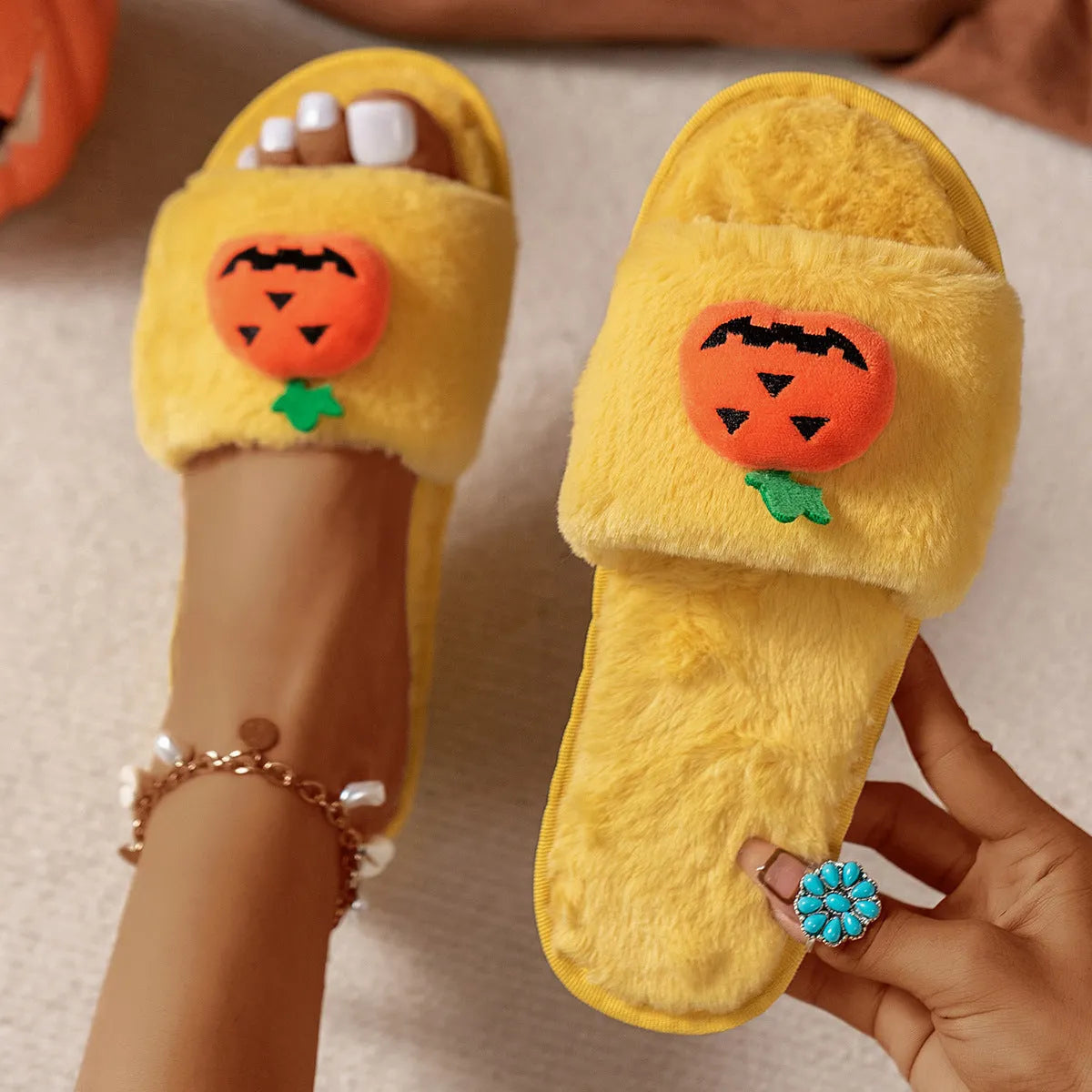 White and yellow Halloween pumpkin cartoon design open-toe plush slippers with synthetic fur.