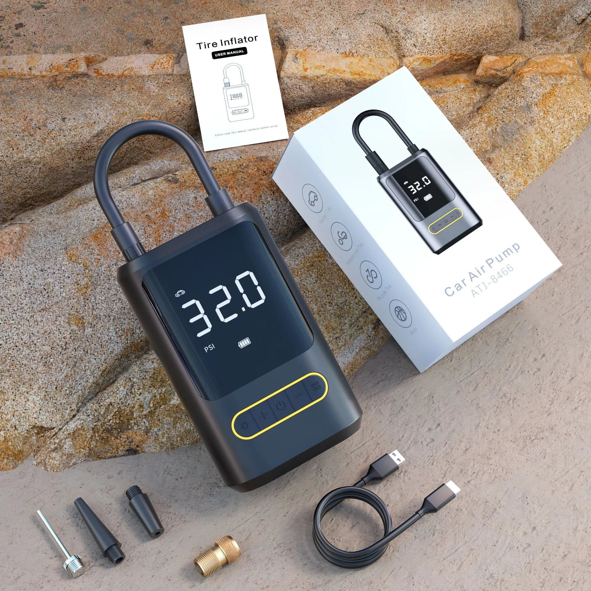 Black handheld digital wireless air pump with LED display and connected air hose on a grey background.