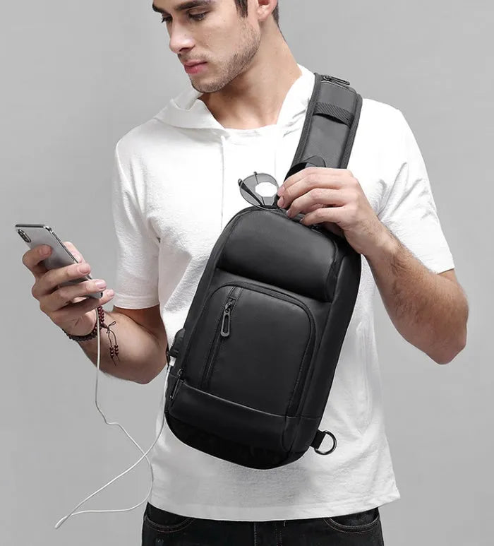 Black outdoor shoulder bag showing internal computer pocket and air cushion shoulder strap