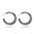Vintage bronze C-shaped alloy earrings with a distressed engraved surface texture.