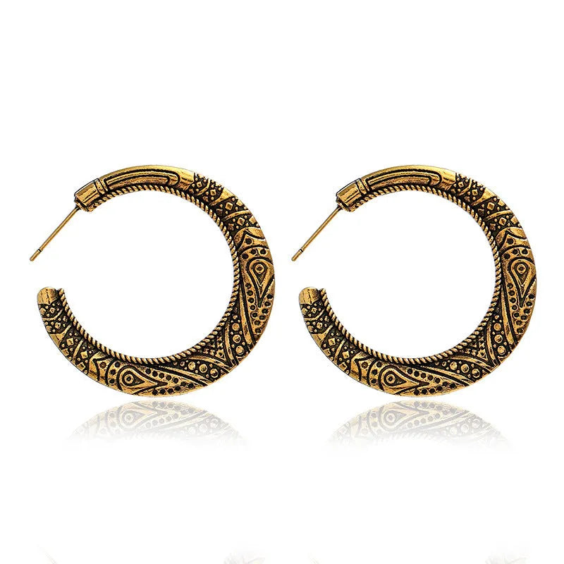 Vintage bronze C-shaped alloy earrings with a distressed engraved surface texture.