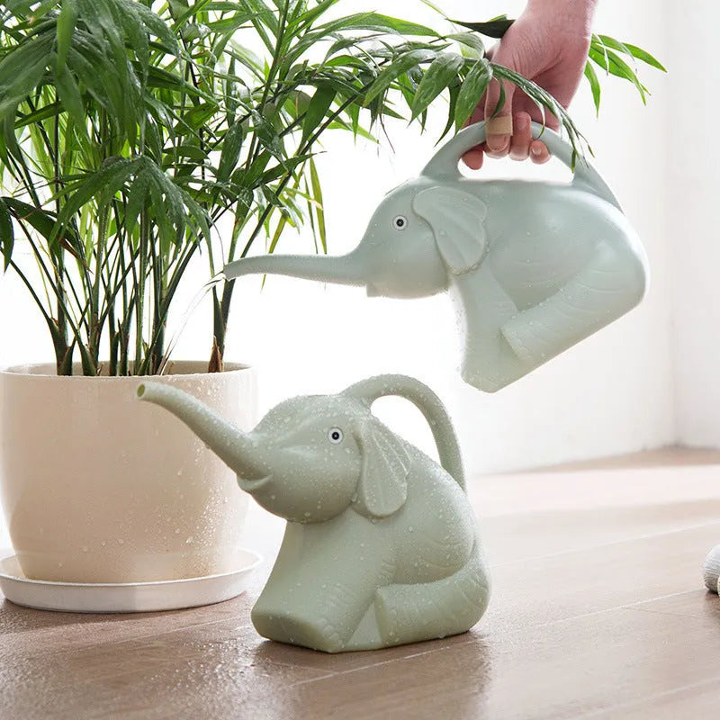 Pink children's watering can in shape of baby elephant with long nozzle and handle.