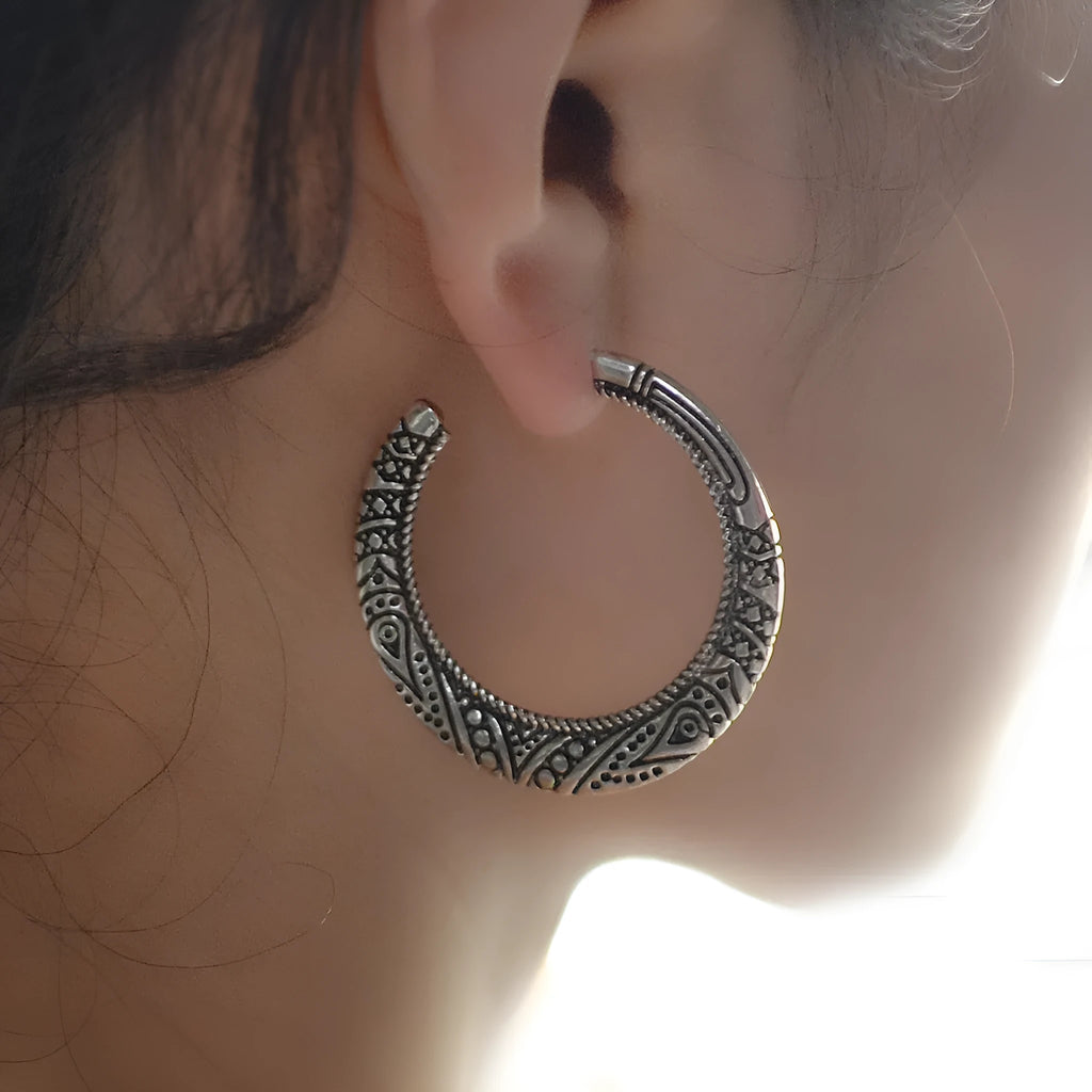 Vintage bronze C-shaped alloy earrings with a distressed engraved surface texture.