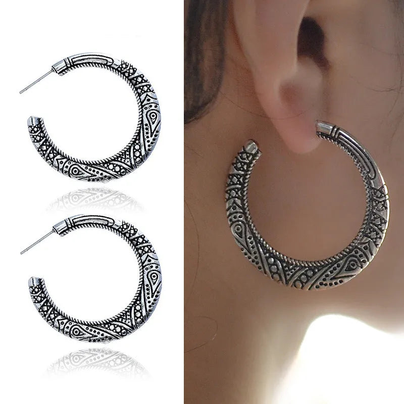 Vintage bronze C-shaped alloy earrings with a distressed engraved surface texture.