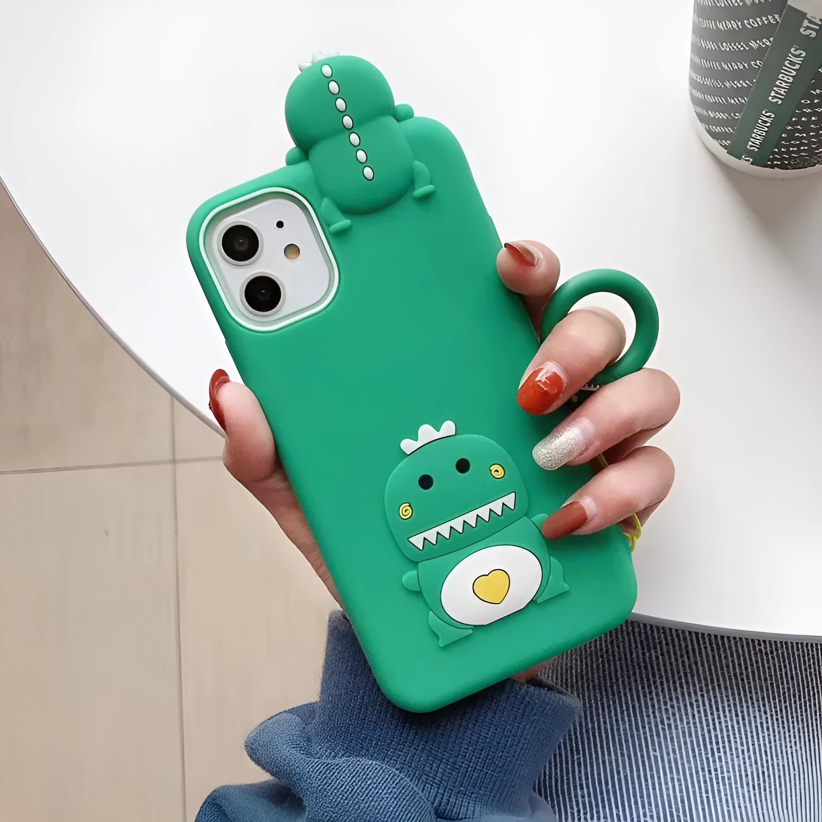 Green silicone iPhone case with cartoon animal design showing drop protection features
