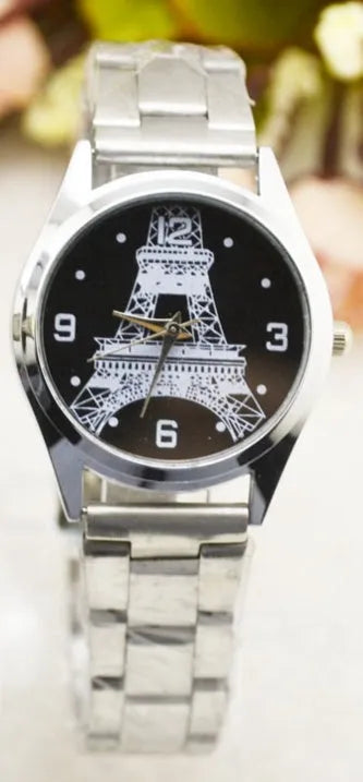 Blue dial Eiffel Tower wristwatch with leather strap on stainless steel buckle.